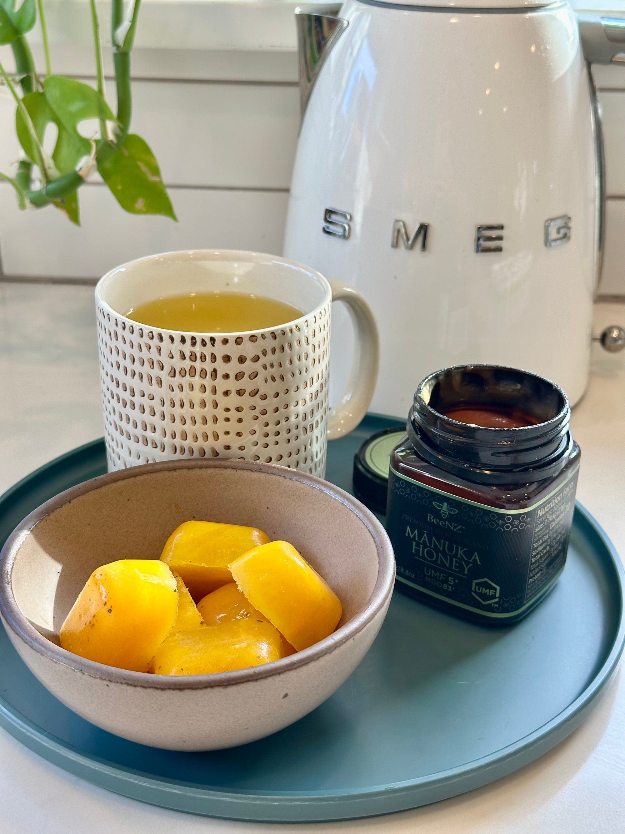 BeeNZ Manuka Honey used to make easy immunity-boosting wellness cubes with ginger, orange juice, lemon, and turmeric. These cubes can be frozen and enjoyed as a natural remedy to support health during seasonal changes.