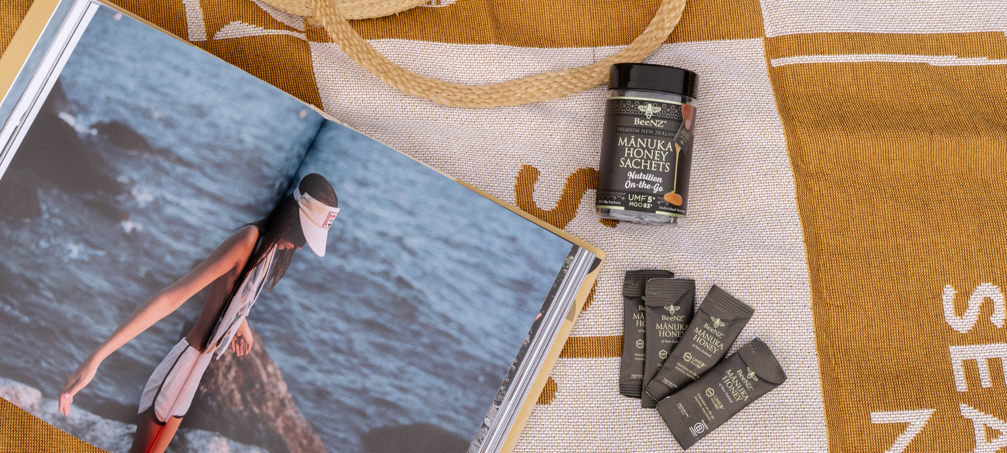 Open book with a person on a beach, jar, and packets on a textured surface.