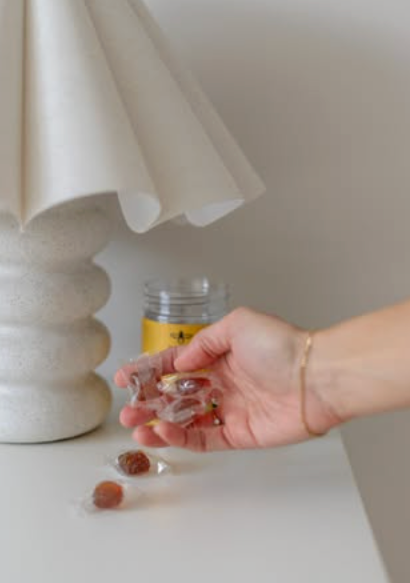 Hand holding BeeNZ honey UMF10+ lozenges 